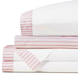 Folded white bedding with pink and white ticking-striped edges, stacked neatly on a clean white background.