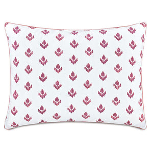 A standard size white pillow sham featuring a repeating magenta ikat pattern and a thin dusty rose corded edge, shown against a plain white background.